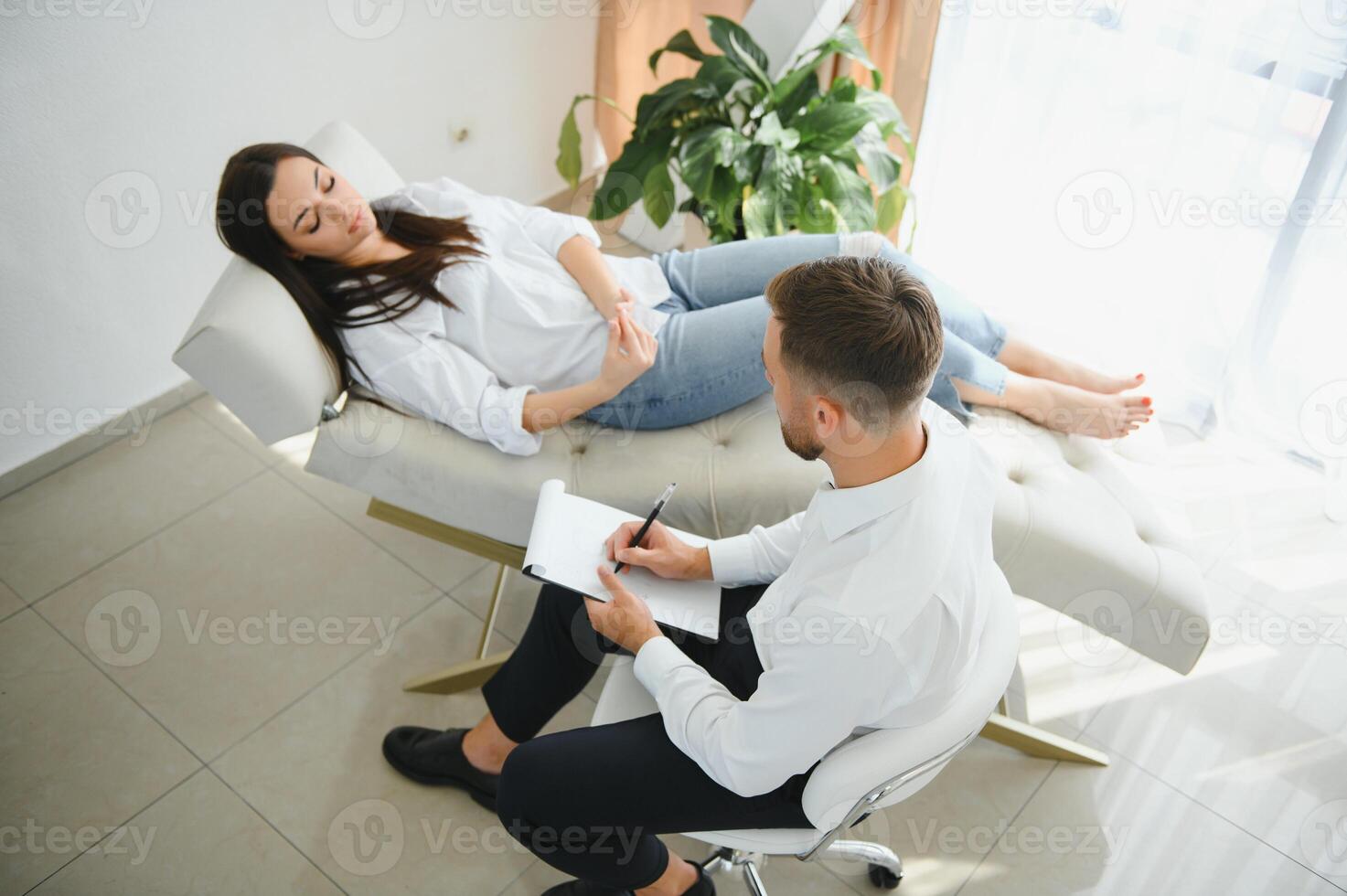 Male doctor and female patient at therapy session photo