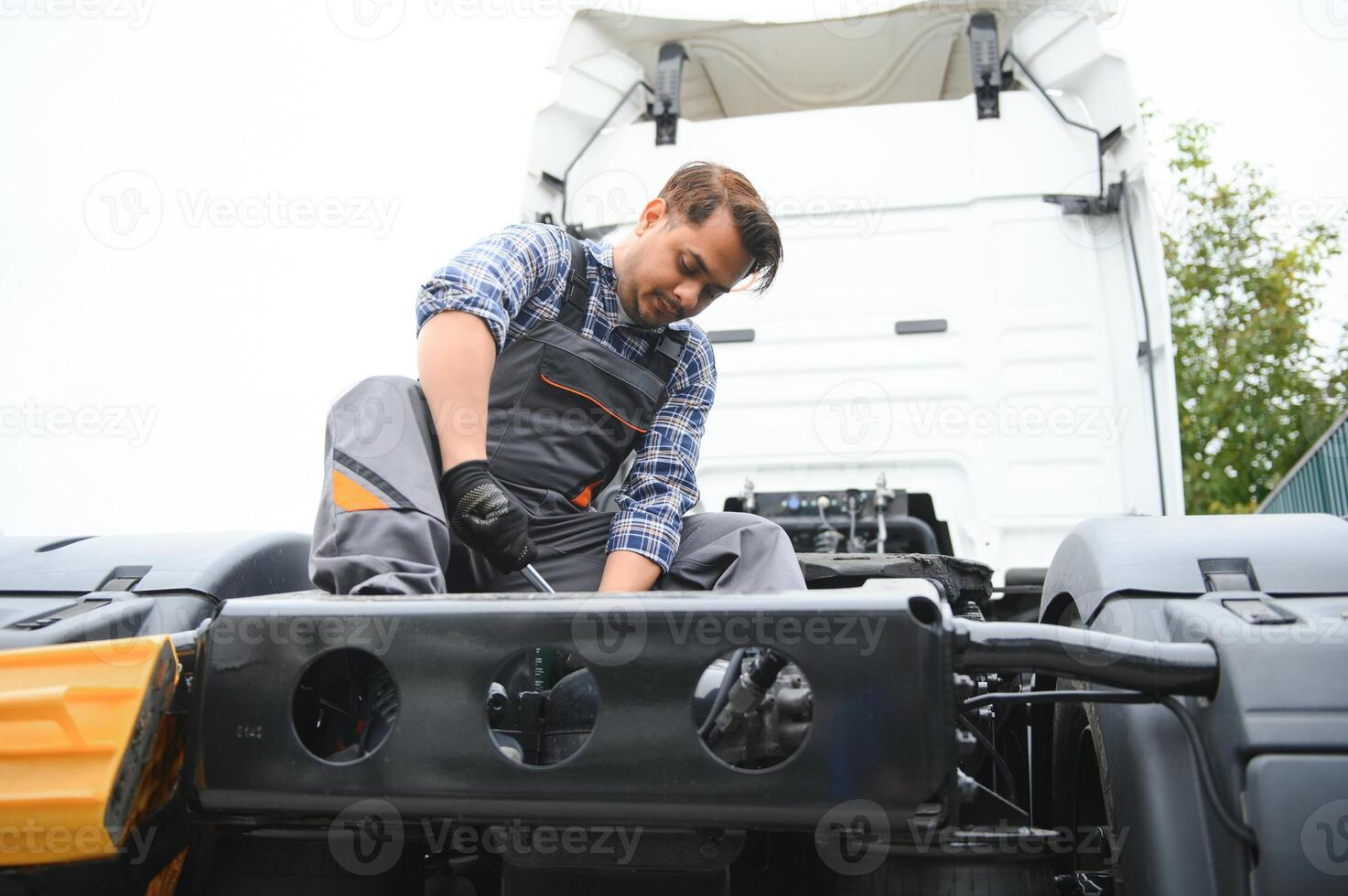 Indian Mechanic repairing the truck photo