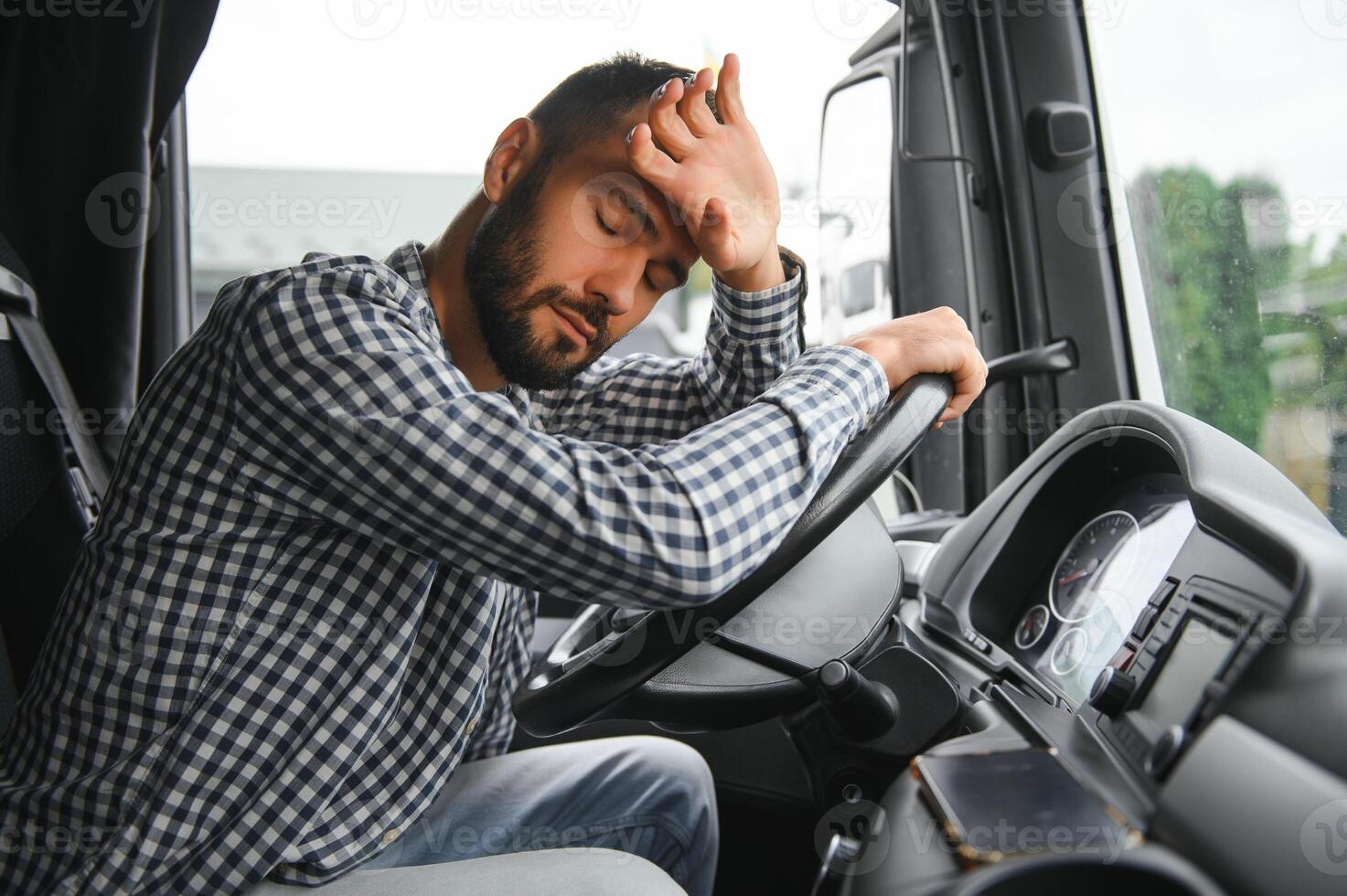Portrait of tired truck driver feeling sleepy and sick. photo