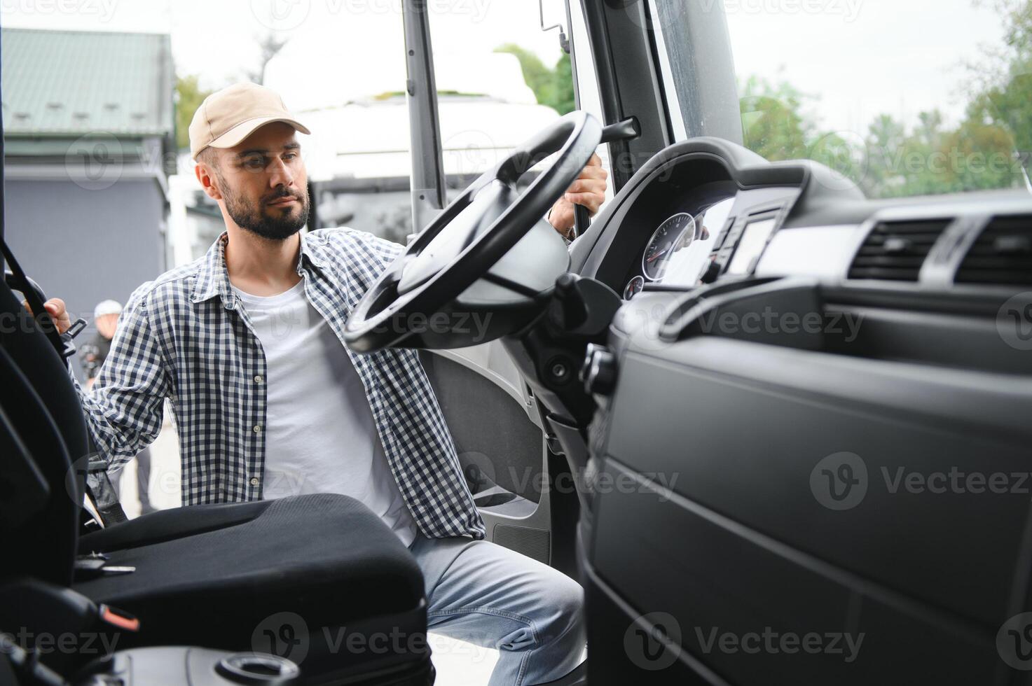 Truck driver climbing into cab of semi-truck photo