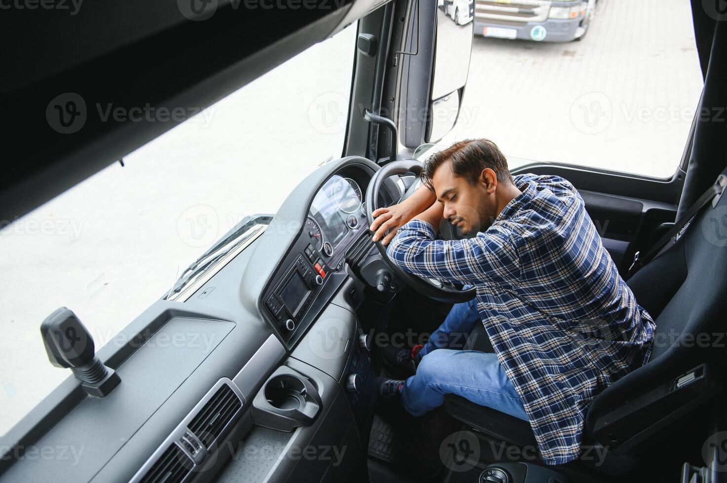 Portrait of tired indian truck driver feeling sleepy and sick. photo