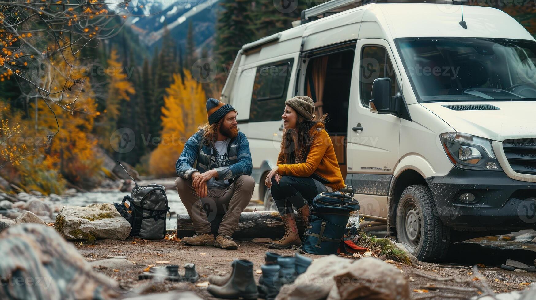 Adventurous Couple Enjoying Autumn by Their Van Near Serene River in Mountain Landscape photo