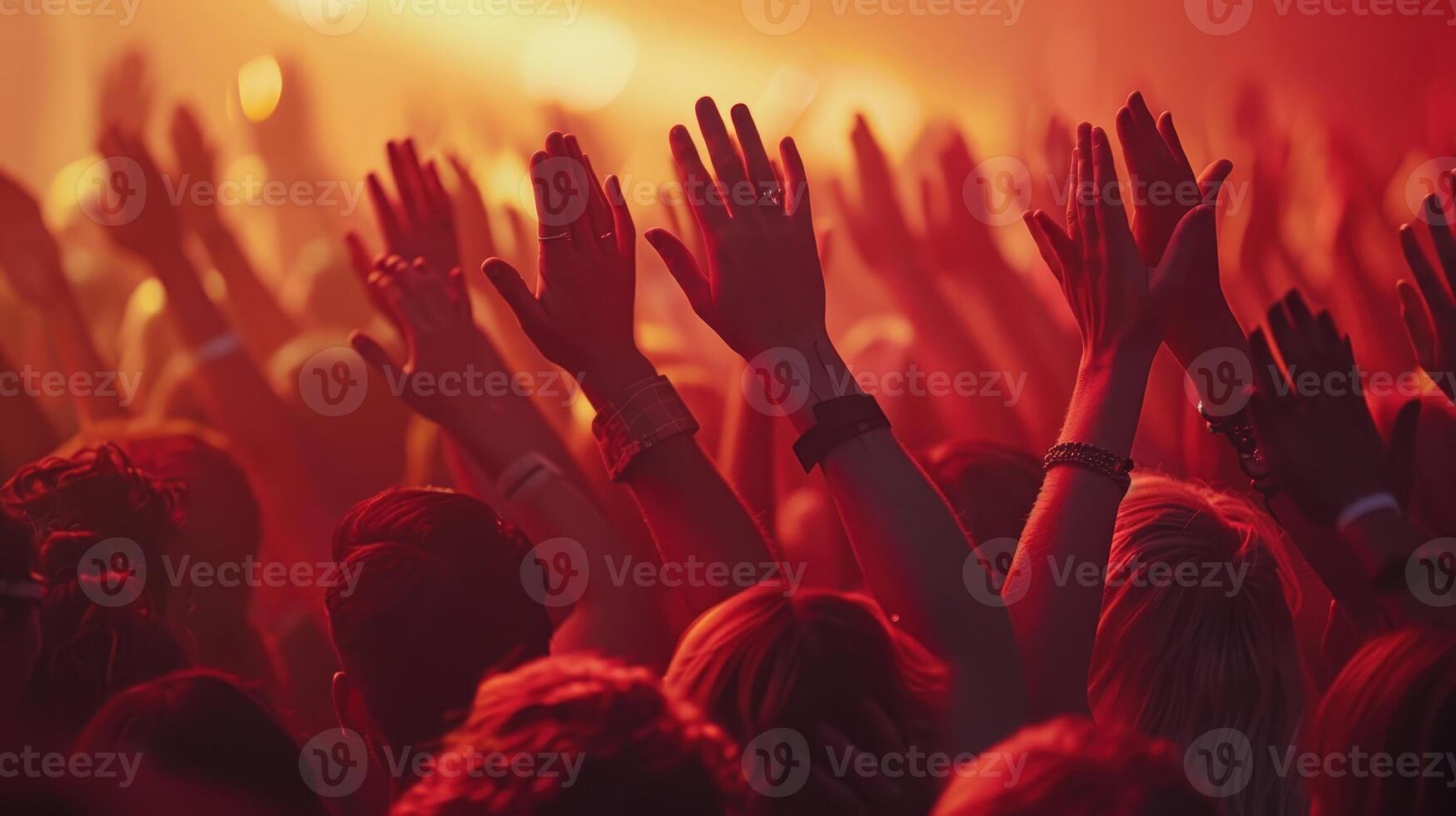 Excited Crowd With Hands Raised in Celebration Under Vibrant Stage Lights at an Evening Concert photo