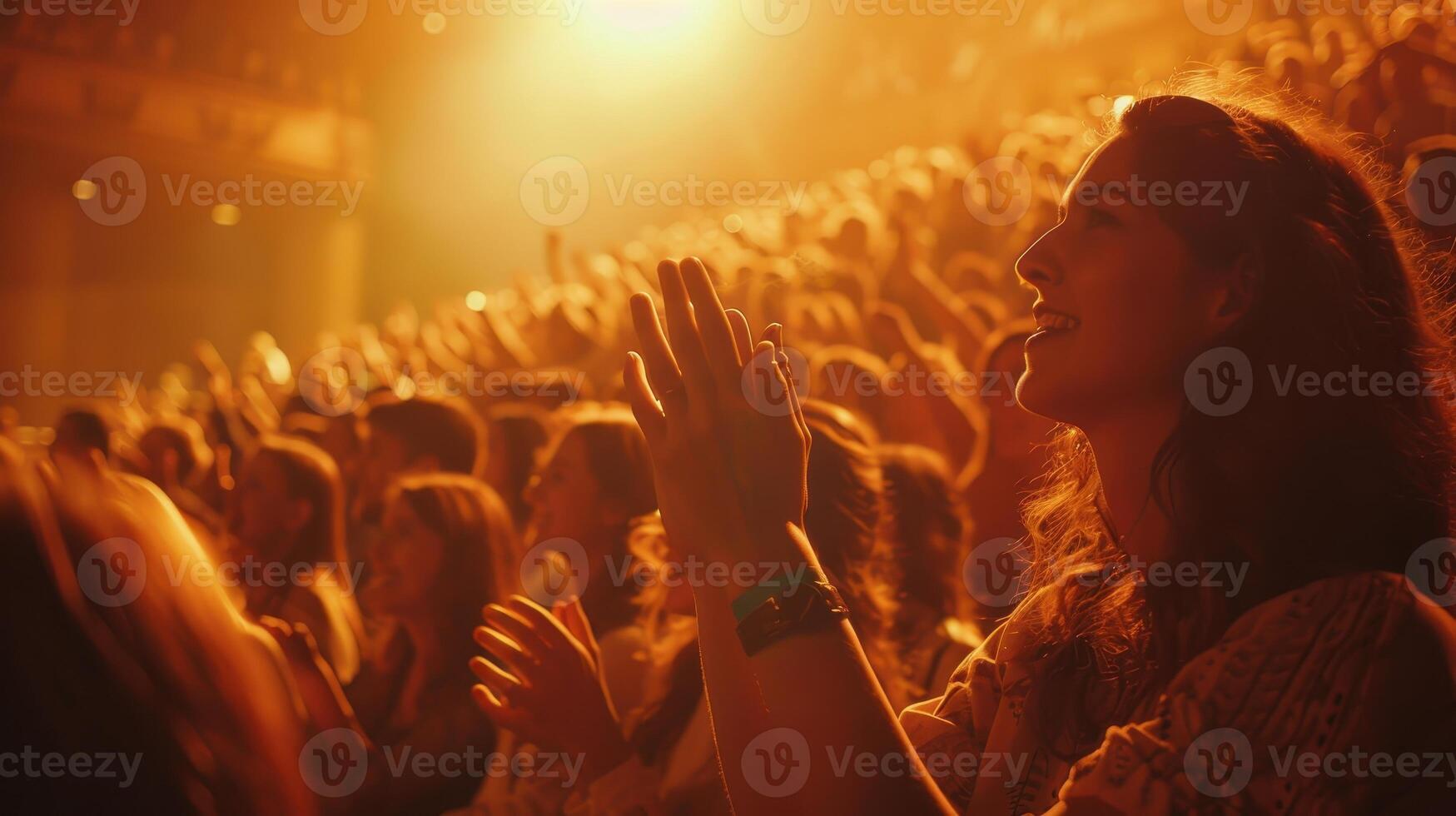 Enthusiastic Crowd Cheering At A Vibrant Live Performance During Golden Hour photo