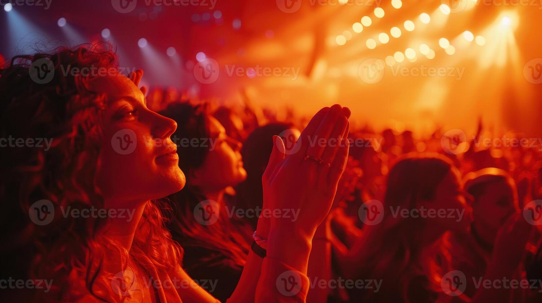 Enthusiastic Crowd Applauding in a Vibrant Concert Atmosphere at Night photo