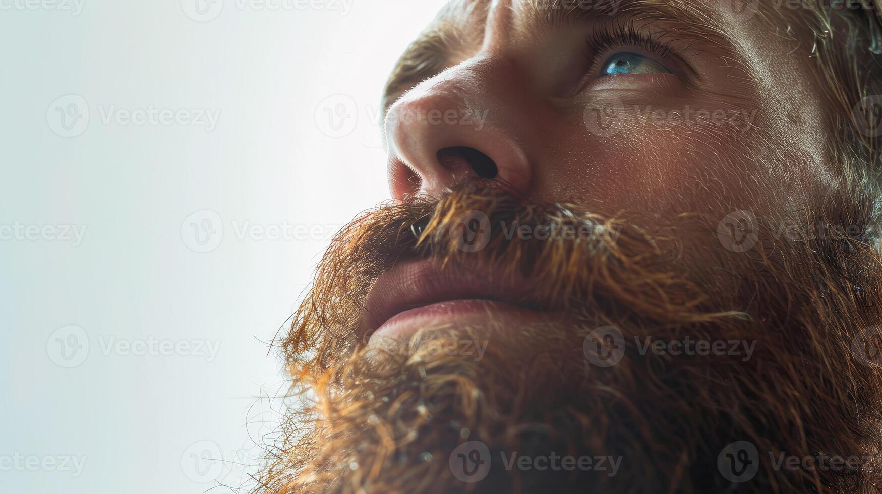 Capturing Introspection and Depth in a Bearded Man's Expression Under Soft Natural Light photo