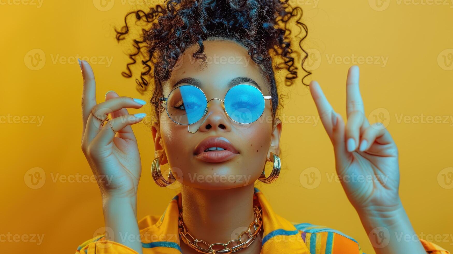 Vibrant Portrait of a Young Woman Posing With Peace Sign Against a Bright Yellow Background photo
