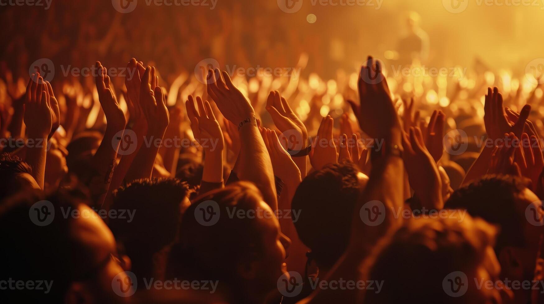 Energized Crowd Clapping Enthusiastically Under Vibrant Stage Lights During Live Music Performance photo
