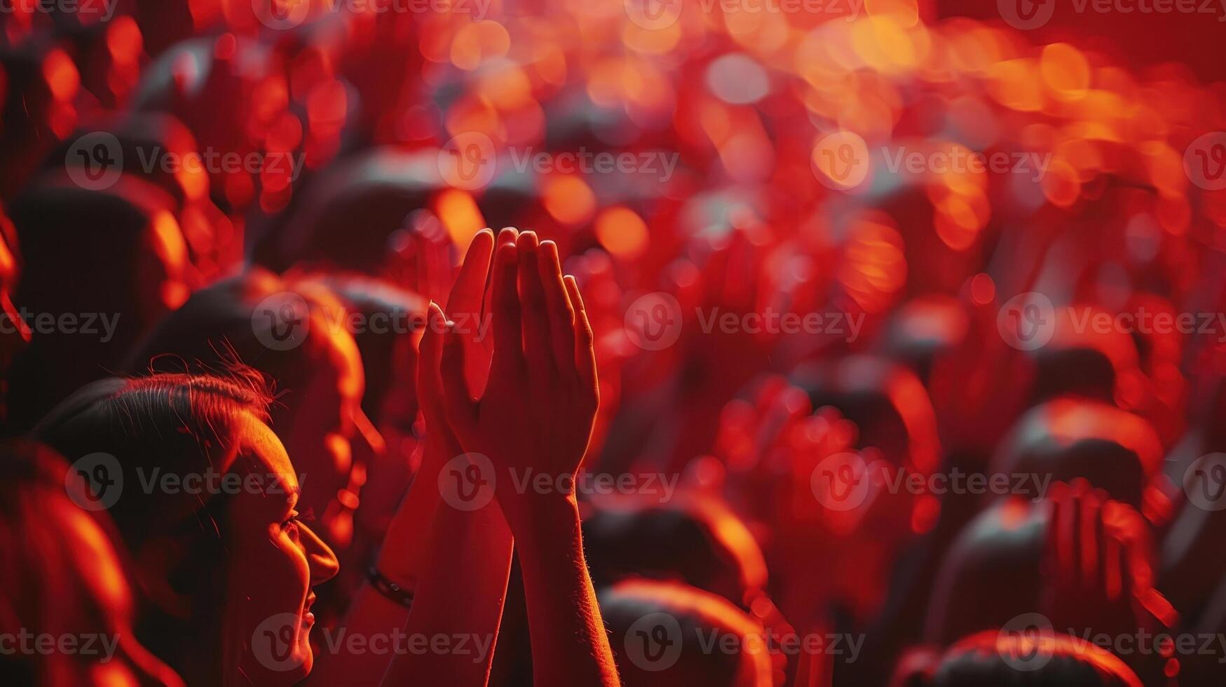 Energized Crowd Celebrating an Unforgettable Performance Under Vibrant Red Lights at an Evening Concert photo