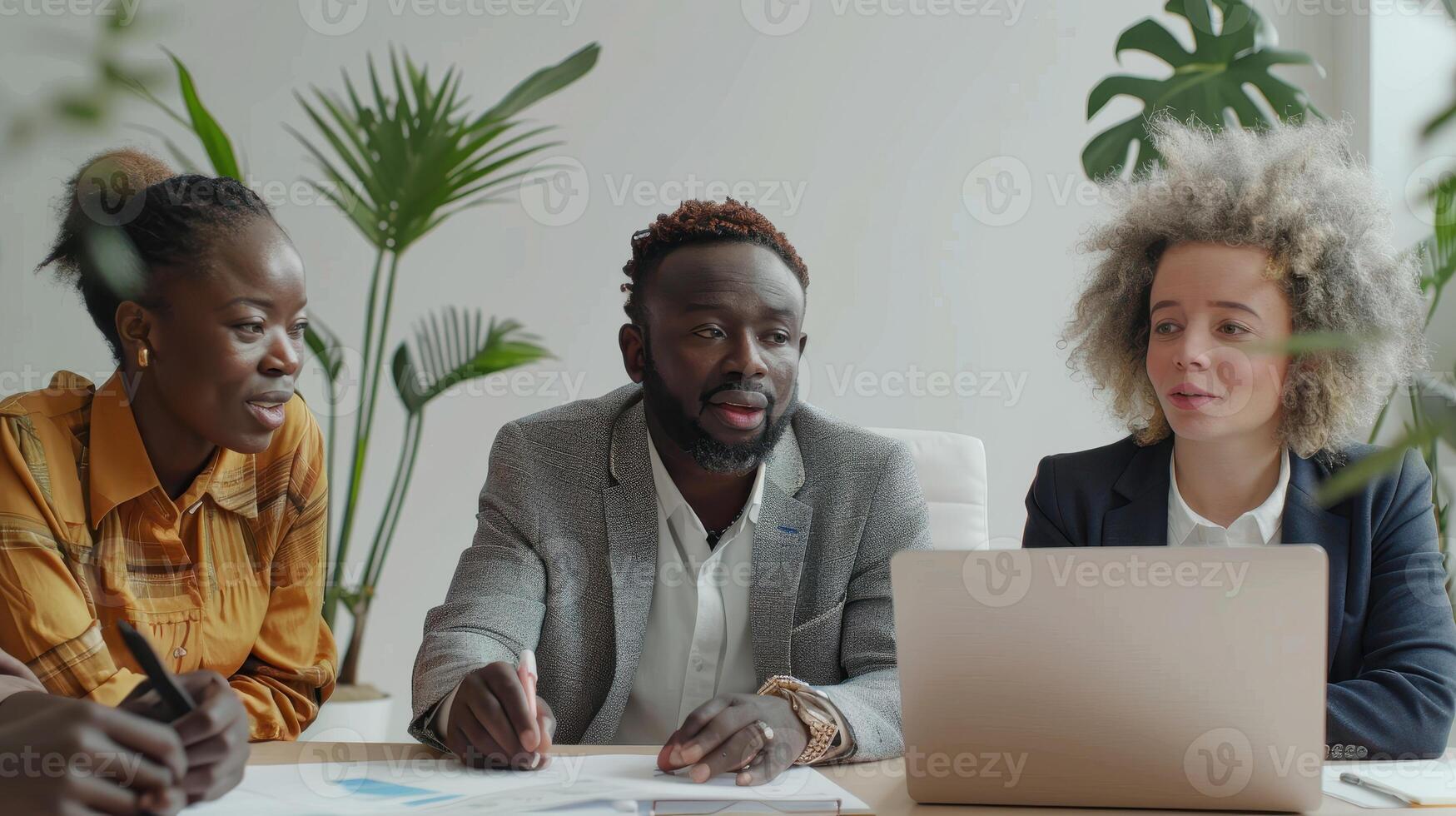 Diverse Team Engaged in Animated Collaboration at Bright Office Space During Afternoon Meeting photo