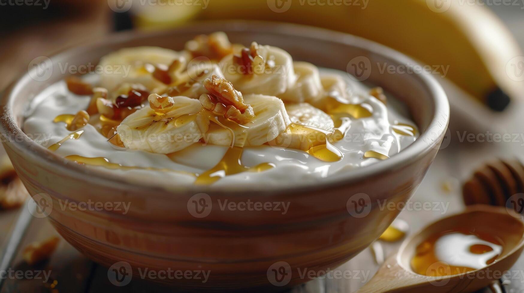 Deliciously Creamy Yogurt Bowl Topped With Fresh Bananas and Crunchy Nuts at a Cozy Breakfast Table photo