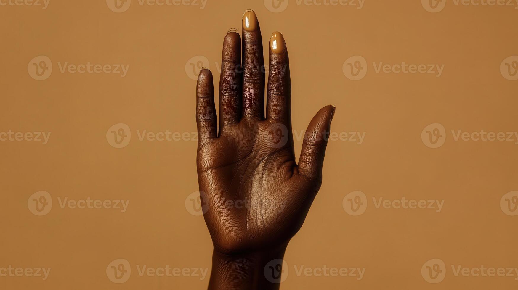 Hand Raised Against Beige Background Demonstrating Gesture of Communication and Expression photo