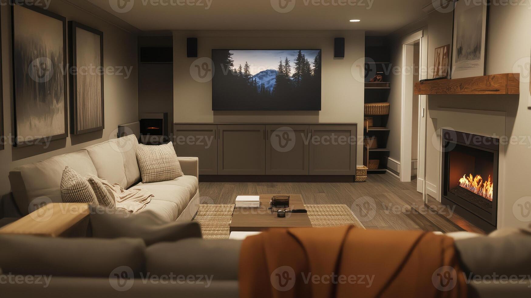 A warm living space features a glowing fireplace and mountain imagery on the screen photo