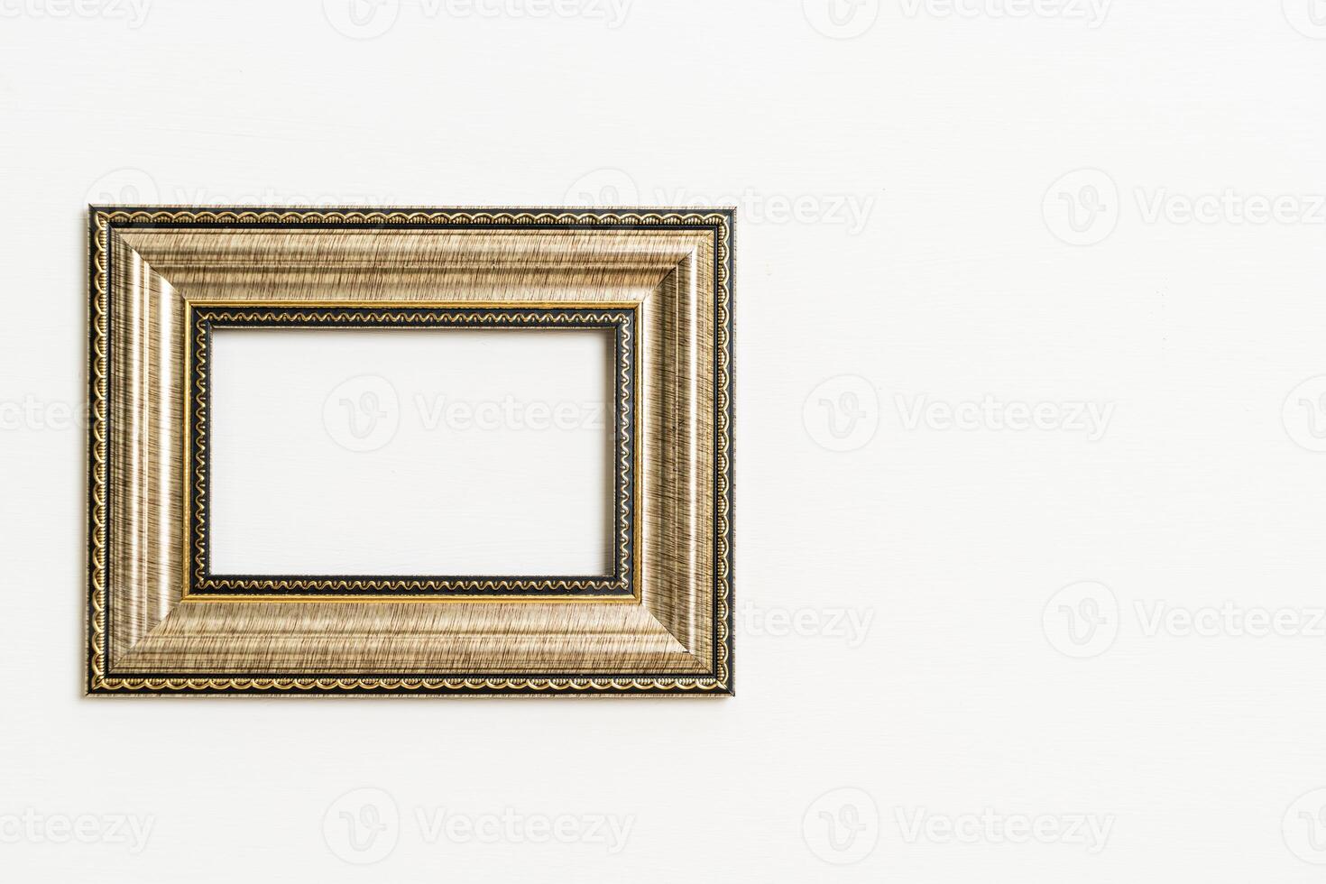 empty picture frame on white wall background photo