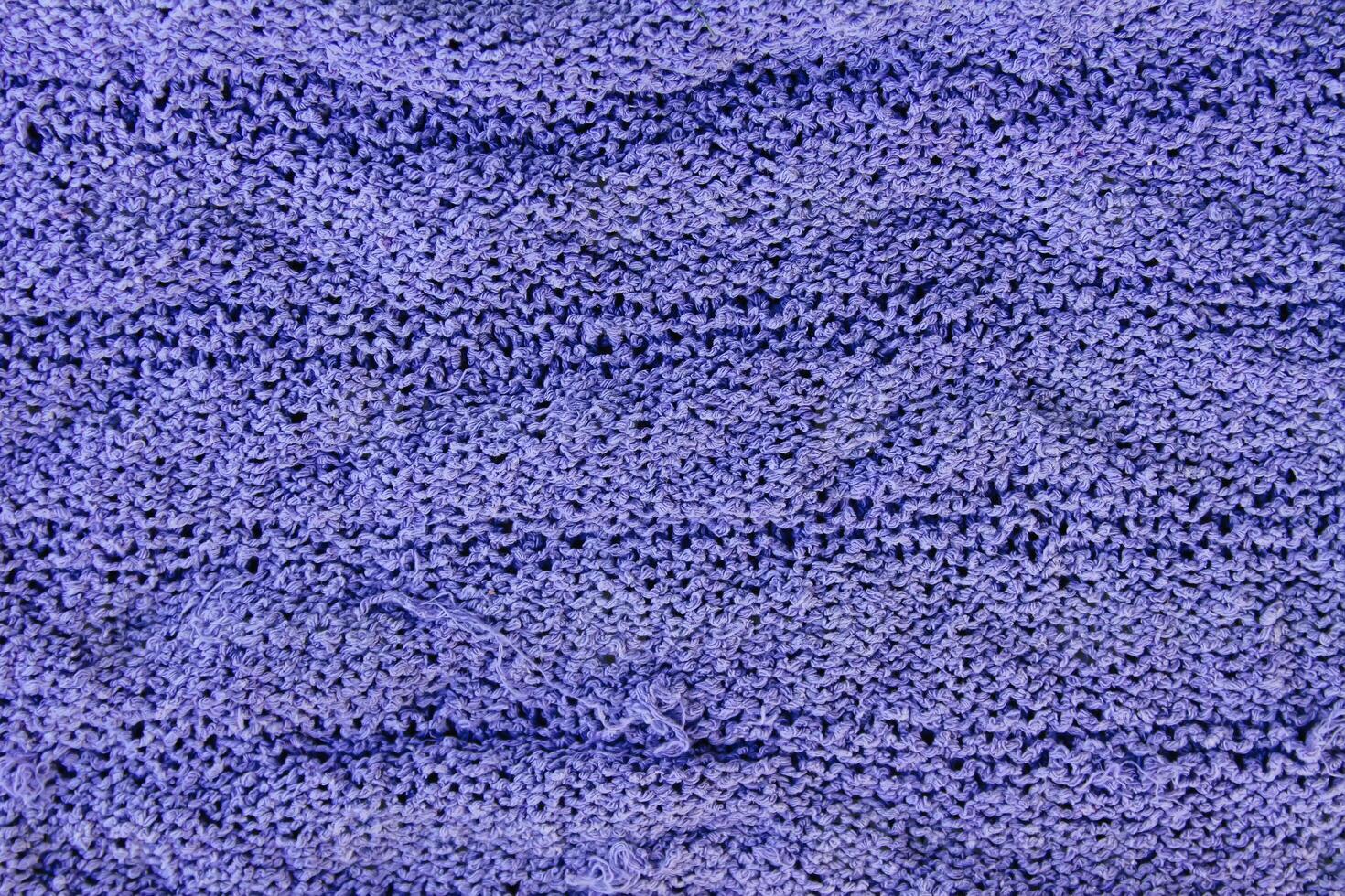 Natural woolen fabric fragment. Knitted texture closeup. Warm yarn background. photo
