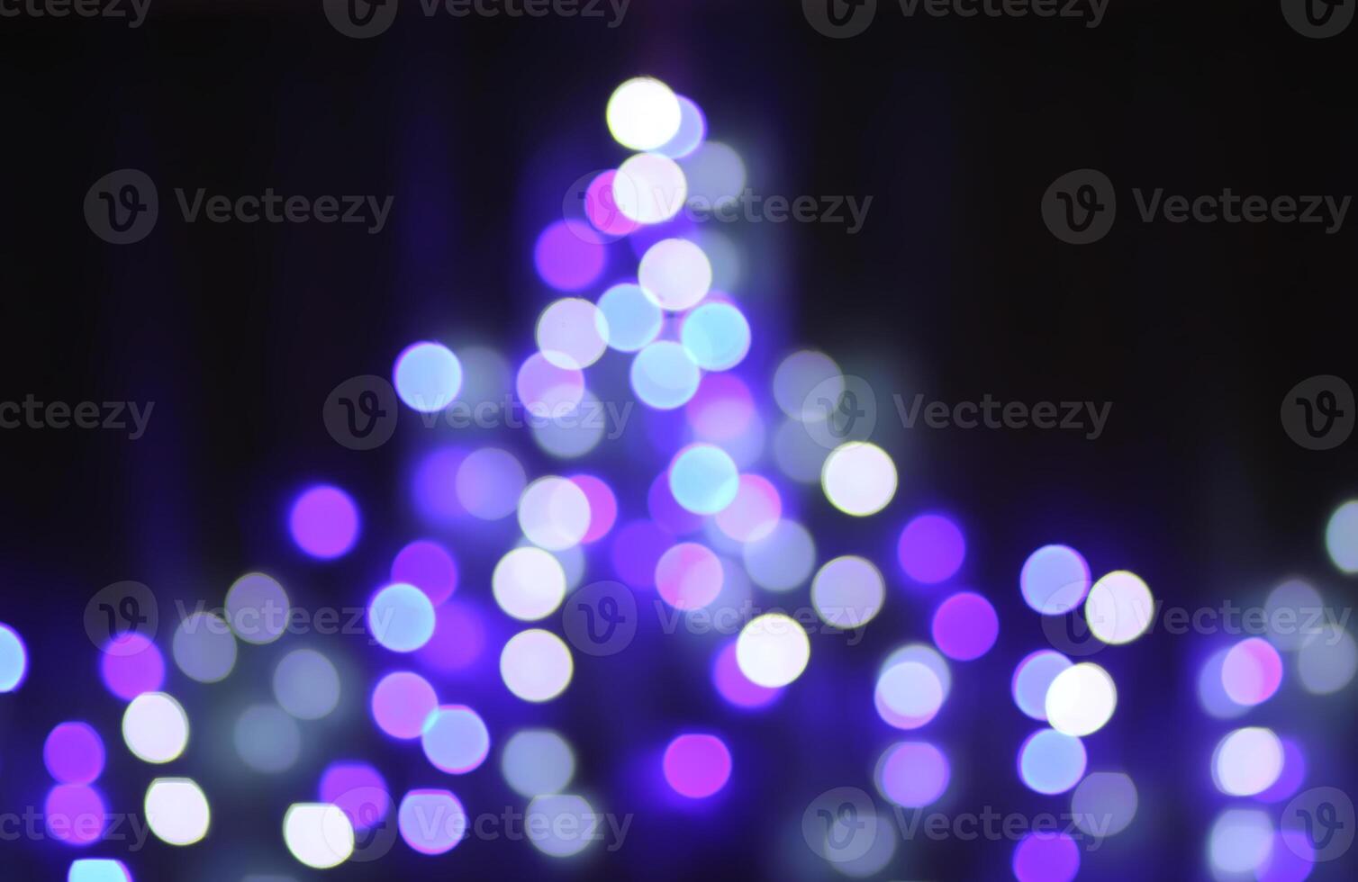 Christmas or New Year festivre blurred background with colorful garland lights photo