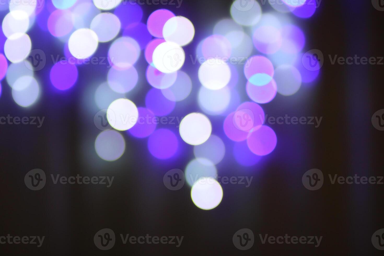 Christmas or New Year festivre blurred background with colorful garland lights photo