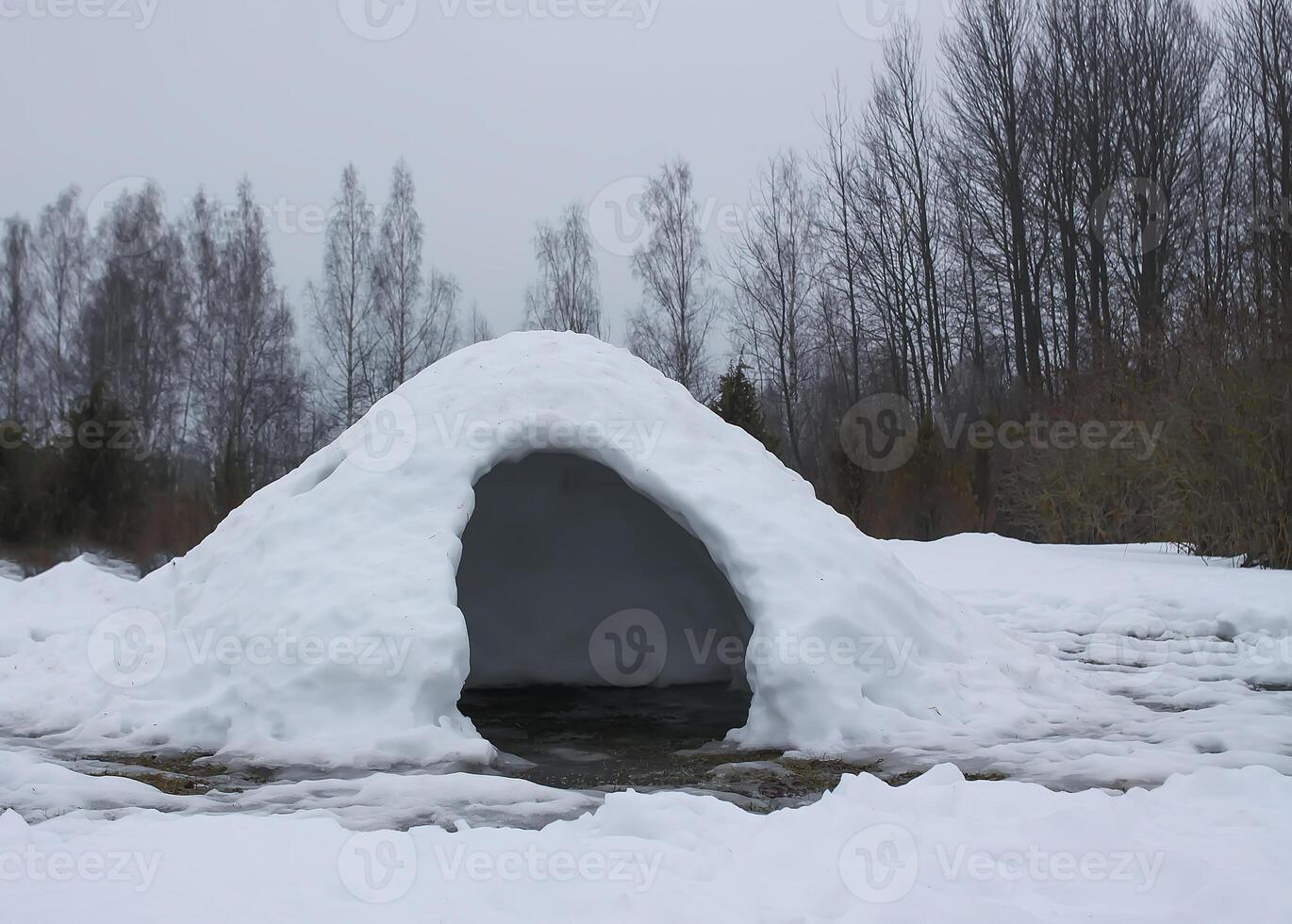 Housem eskimos igloo or yurt made by children from snow in a thaw in winter day. photo