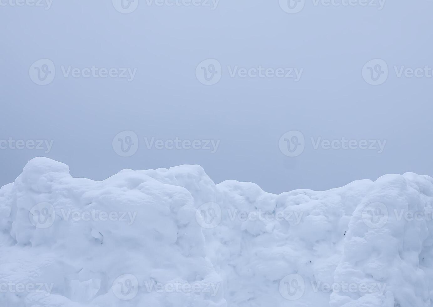 Wall made of snow on rural field photo