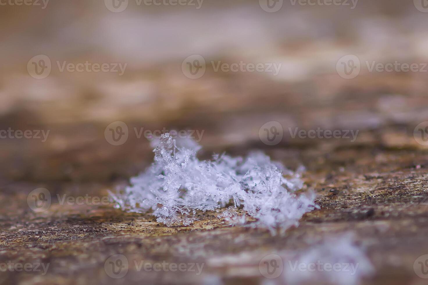Snowflakes during the snowfall on glass surface photo