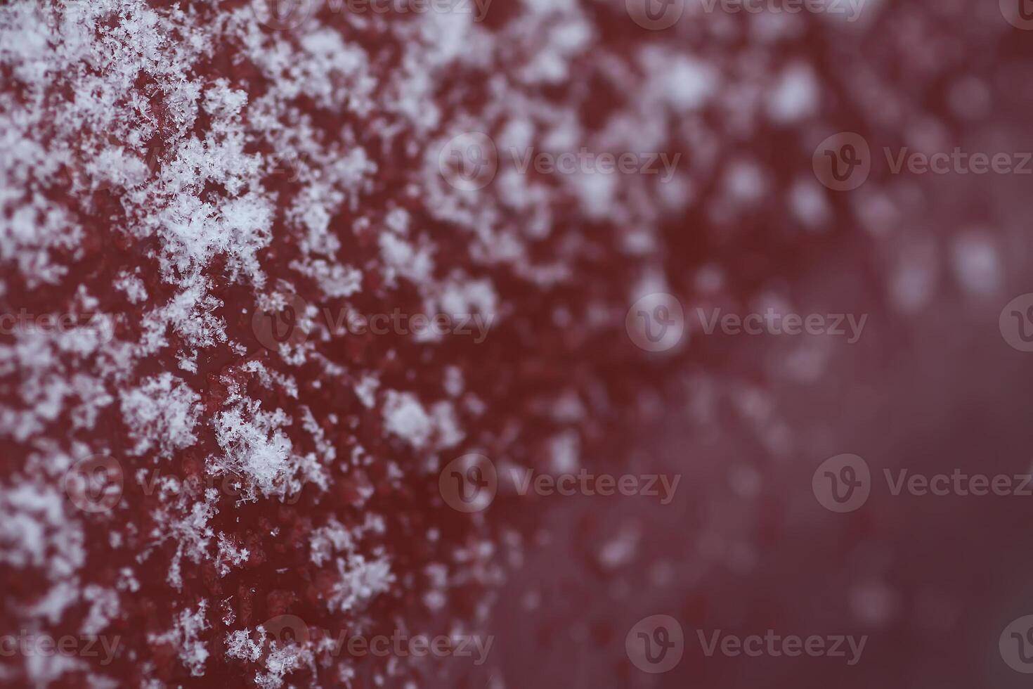 Snowflakes during the snowfall on glass surface photo