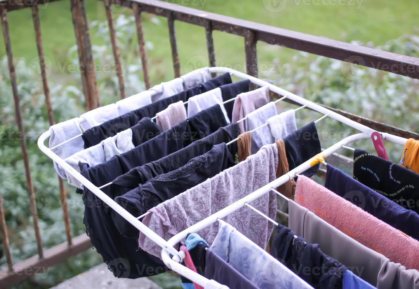 Clean clothes hanging on dryer outdoors. photo
