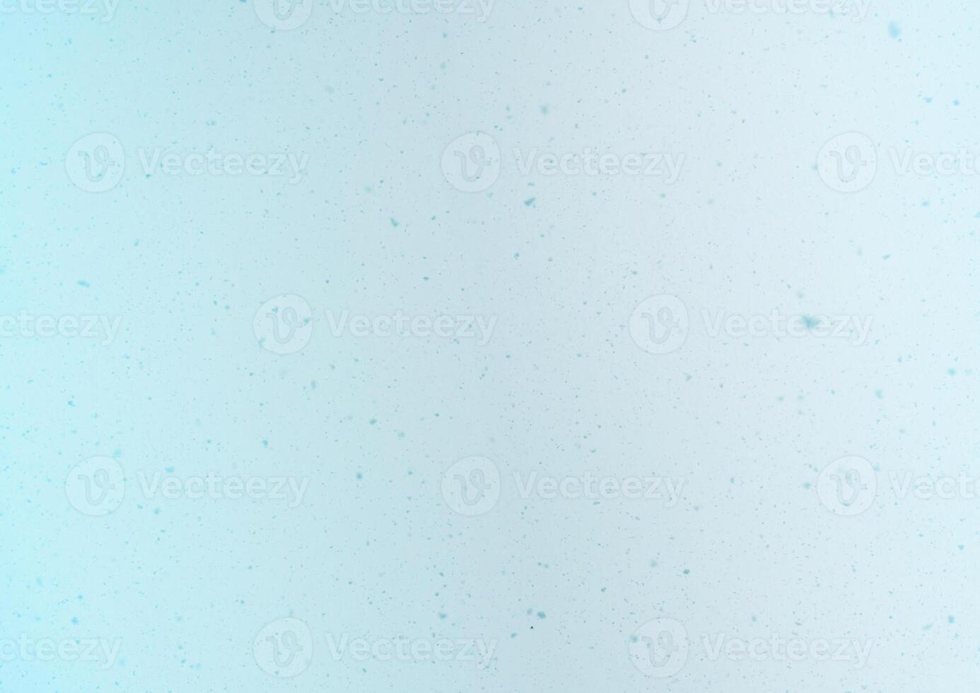 Blurred winter photo overlay. Empty space. Light background with fluffy flying snowflakes.