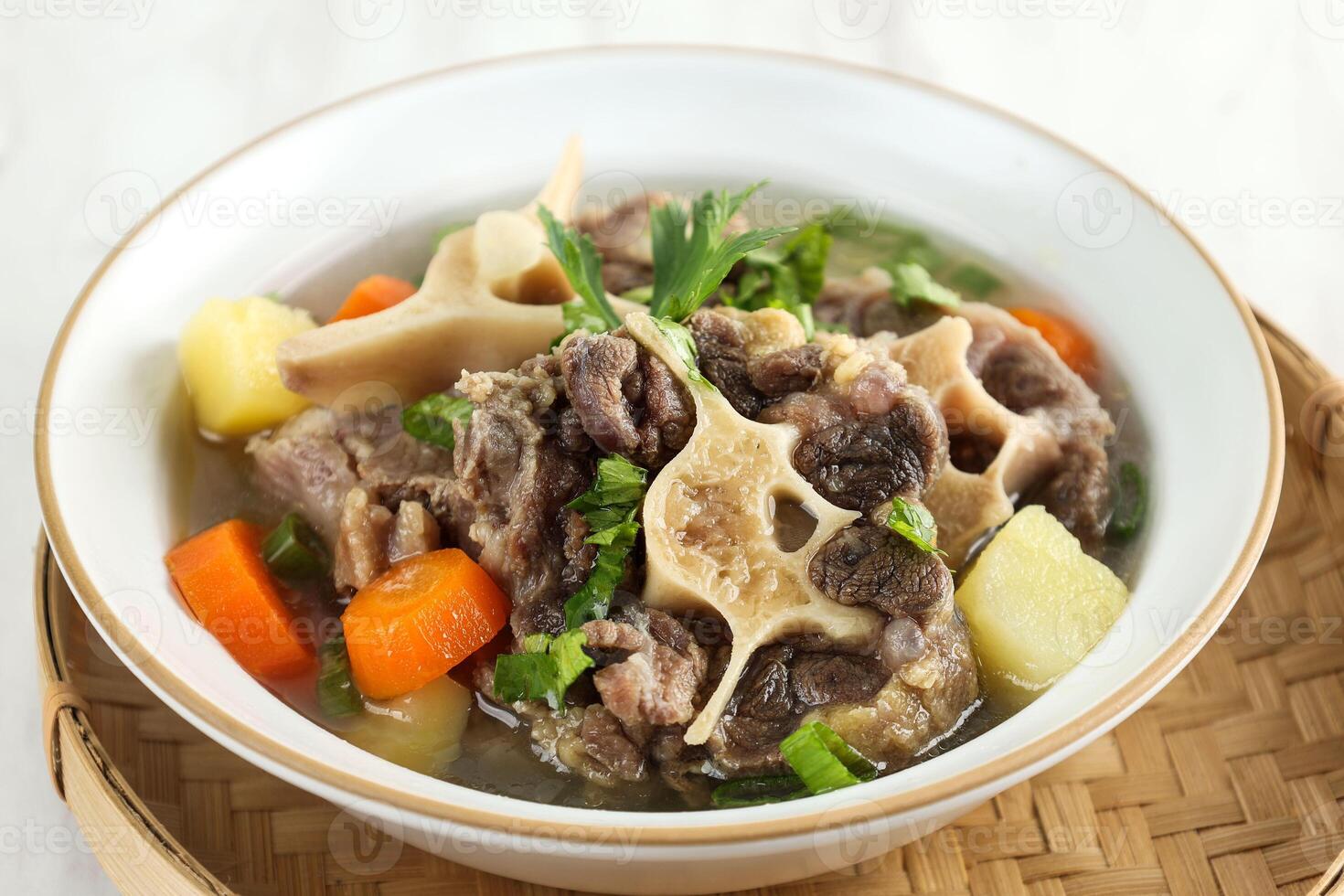 Indonesian Oxtail Clear Soup or Sop Buntut with Potato and Carrot photo