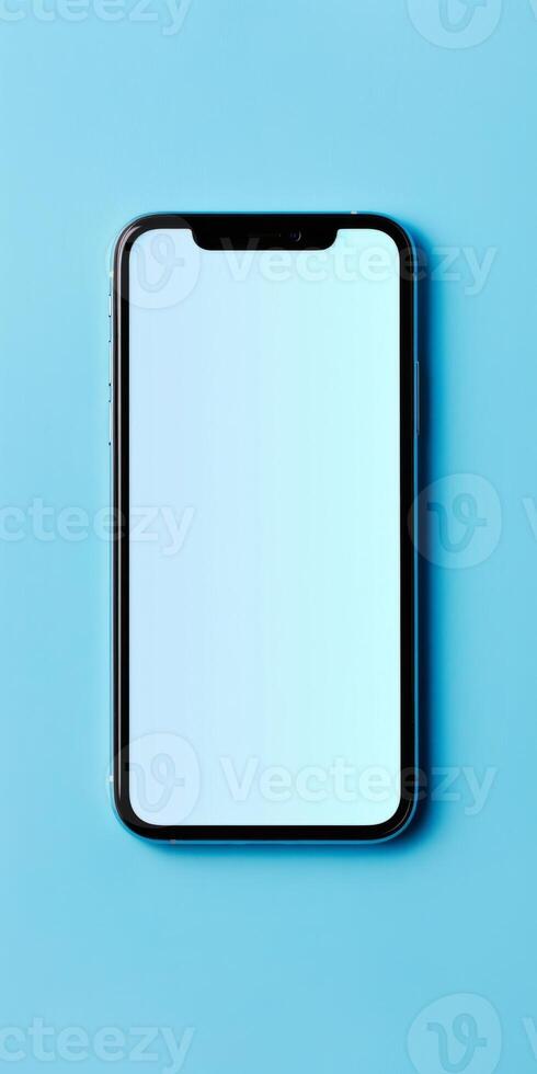 Smartphone with white screen is lying on a blue background, showcasing its sleek design and large display photo