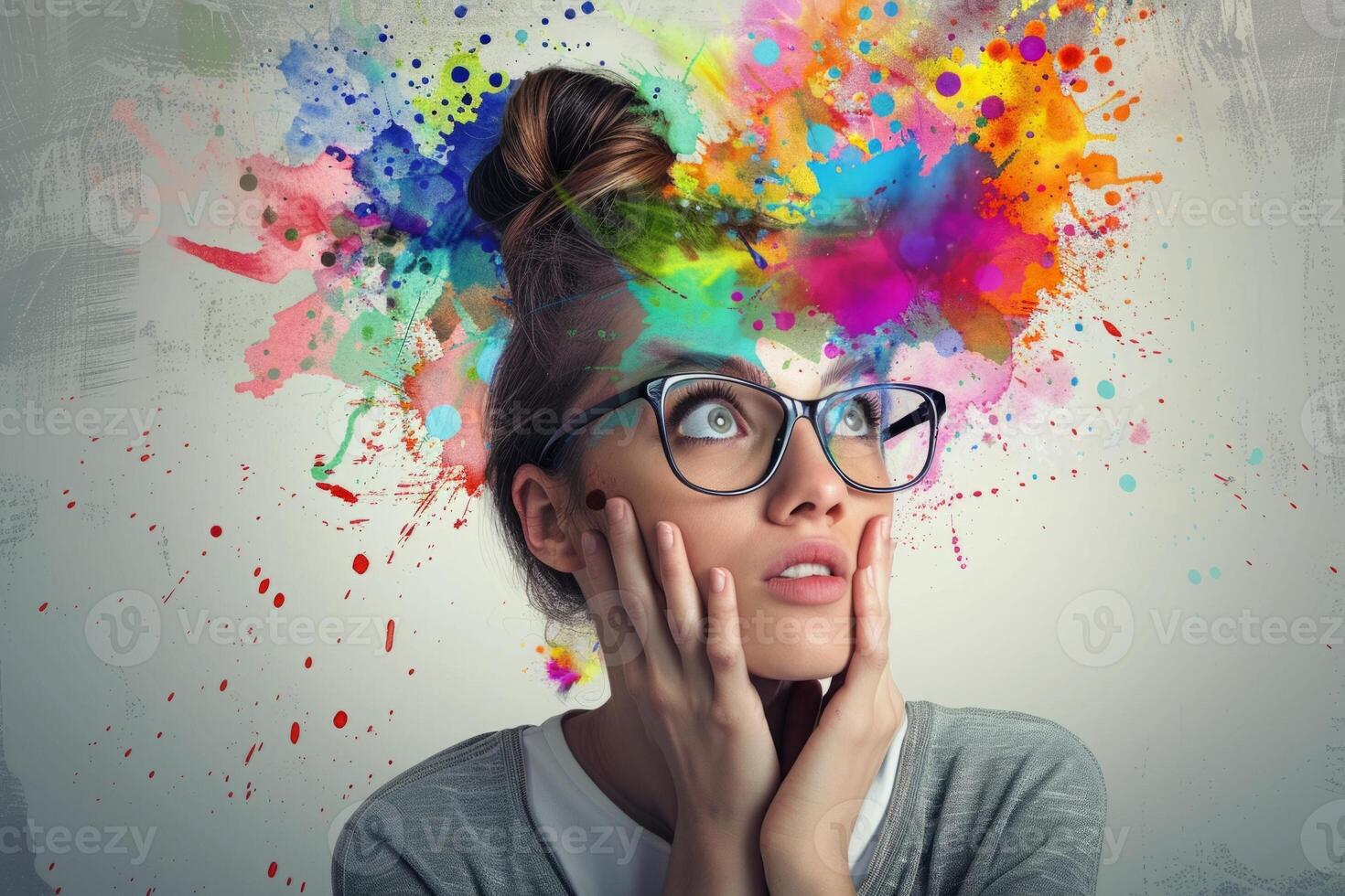 Young woman is having a creative idea with colorful paint splashing from her head photo