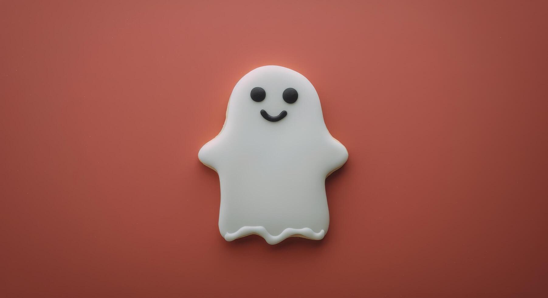 Cute Ghost-Shaped Cookie on Red Background for Halloween Celebration photo