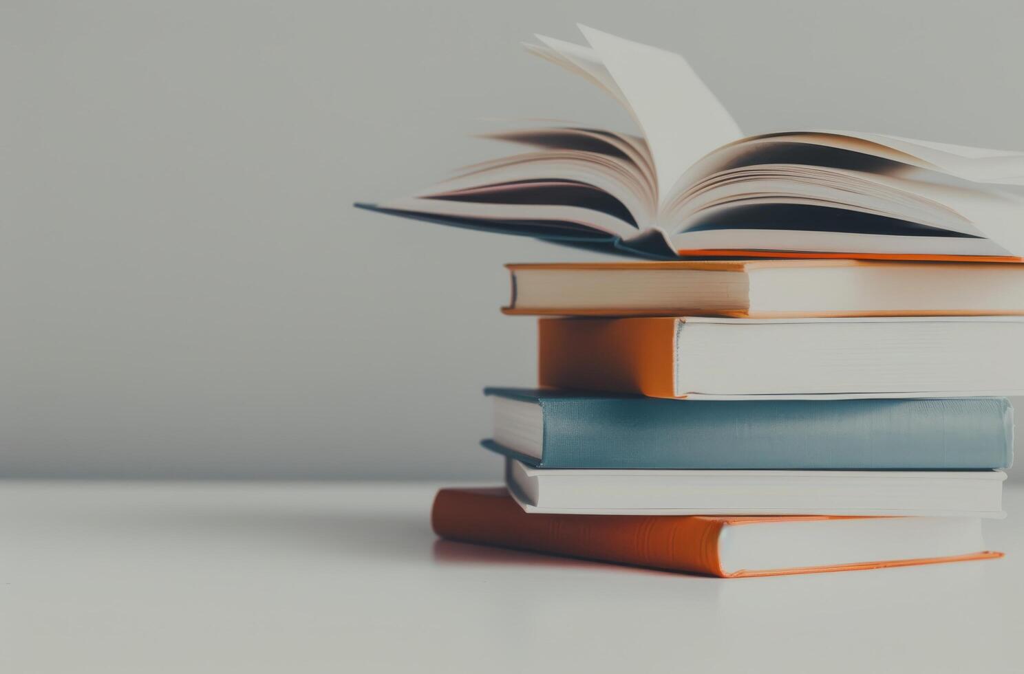 Floating Book Above Stack With Coffee Cup and Decorative Flowers in Minimalist Setting photo