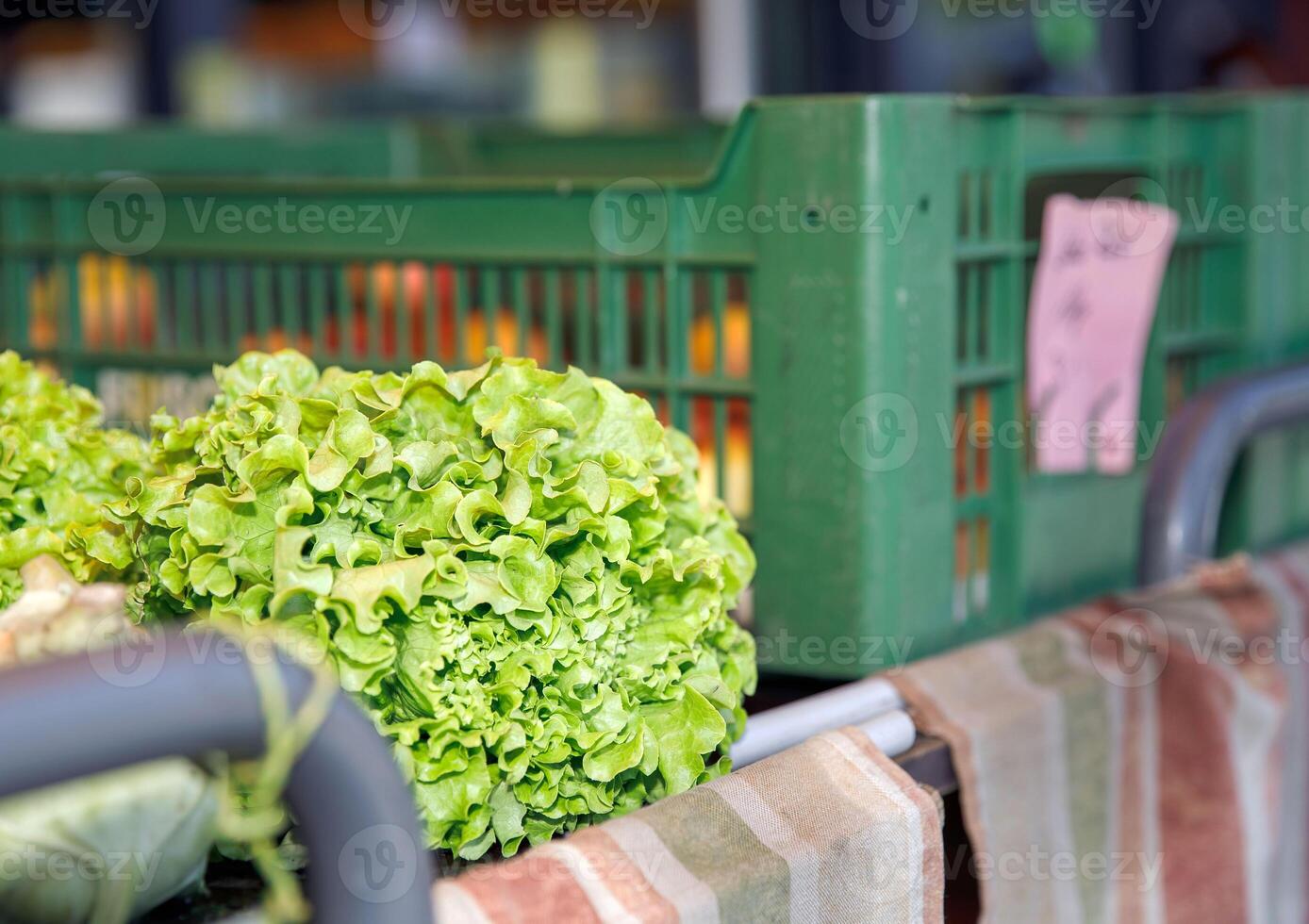 Fresh crisp green lettuce, neatly placed in a plastic crate at a farmers market, healthy eating concept photo