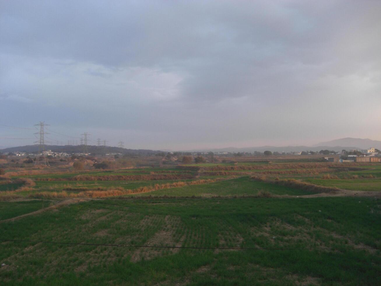 Beautiful View of fields in village - Captured from height - Electricity Wire - Stock Photo