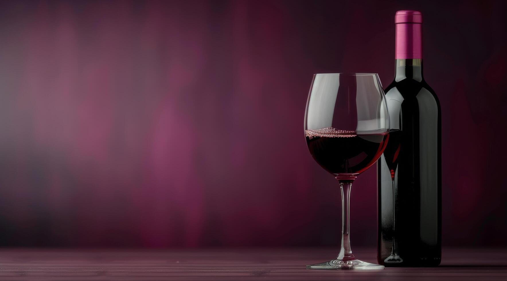 Red Wine Glass and Bottle on Table photo