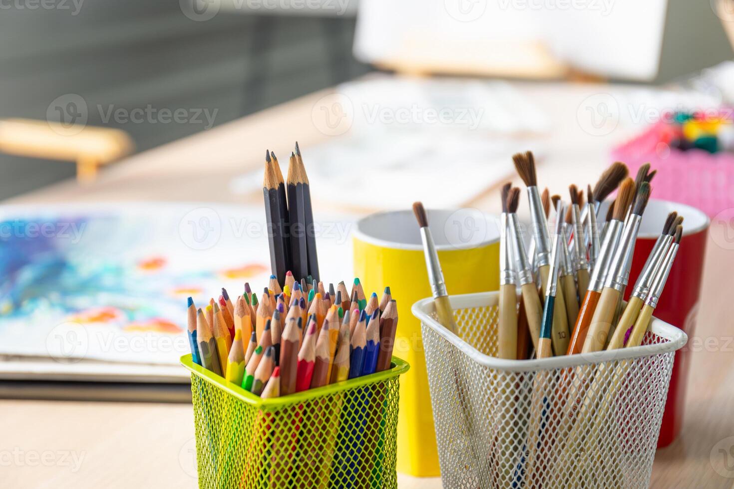 Artist's tools with brushes and different paints in a box on table photo