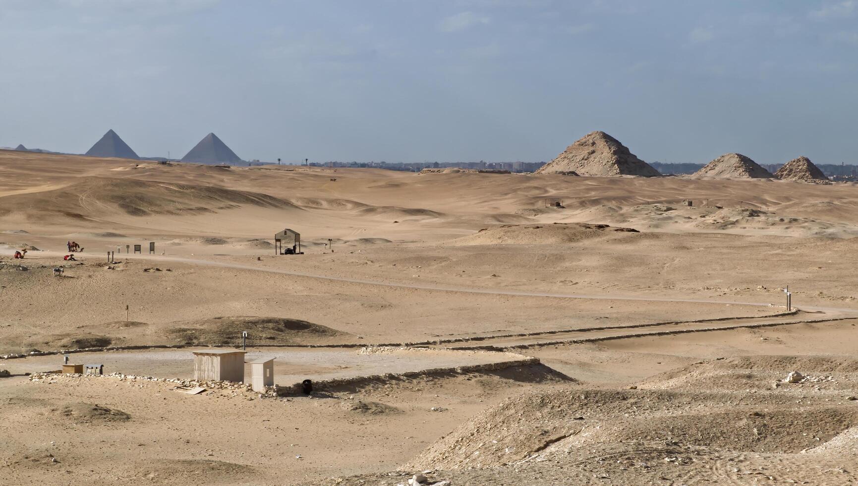 Golden desert landscape featuring ancient pyramids photo