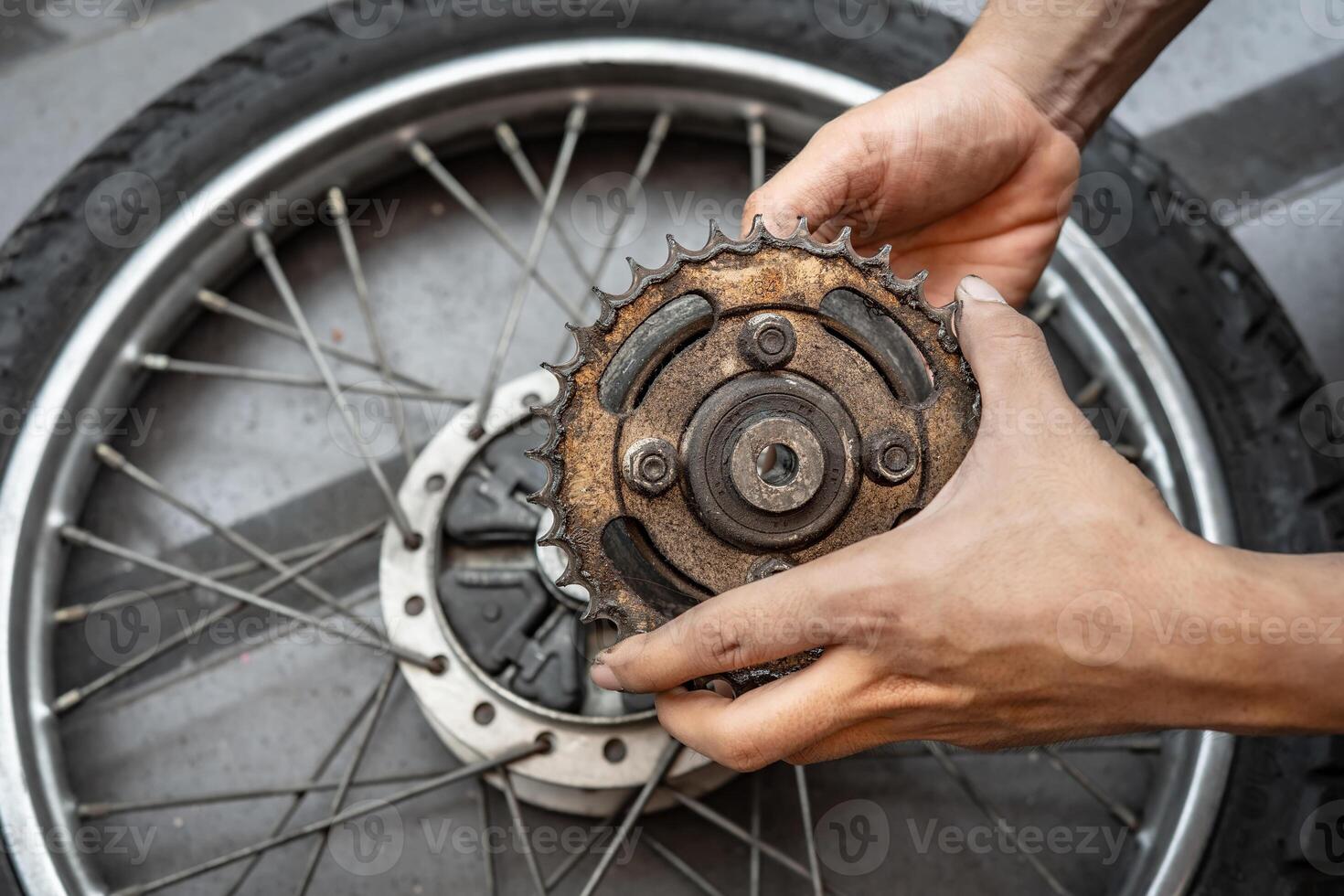 Professional mechanic repair , Replace the Chain and Sprockets on motorcycle in garage,worn out sprockets. maintained and repair concept. photo