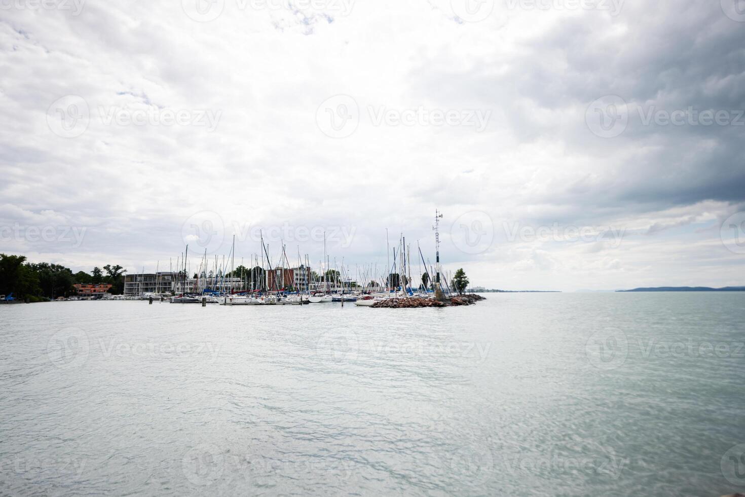 Scenic view of sailboats docked at a marina on a cloudy day in Siofok, Balaton lake, Hungary. photo