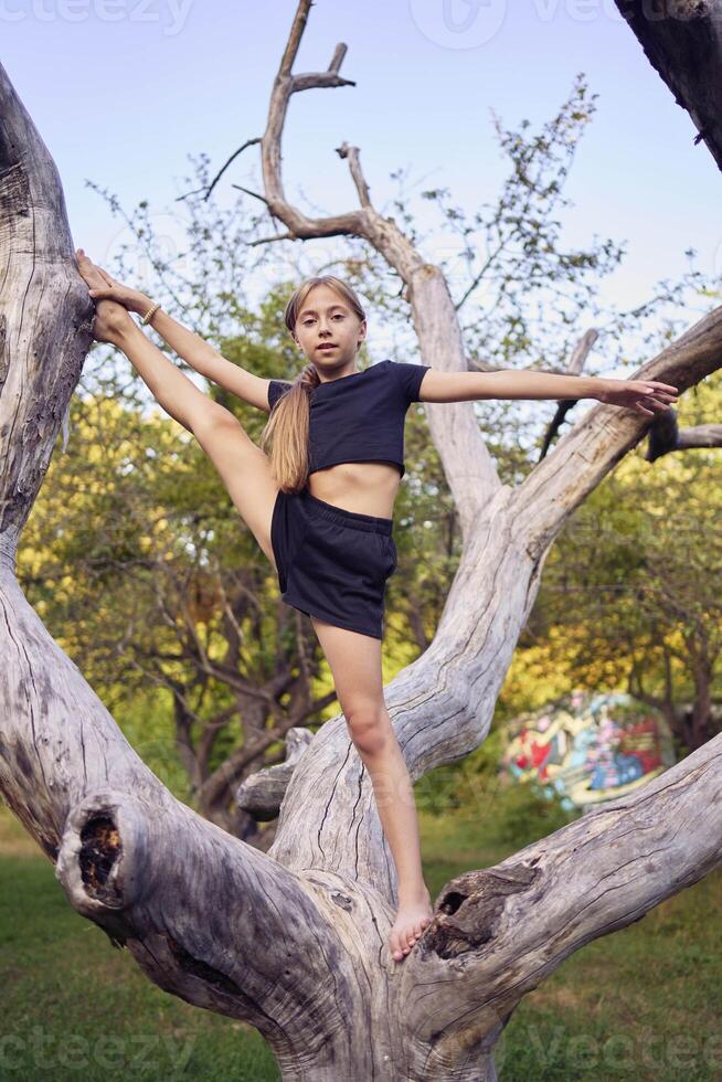 A 10-year-old gymnast practices in the garden photo