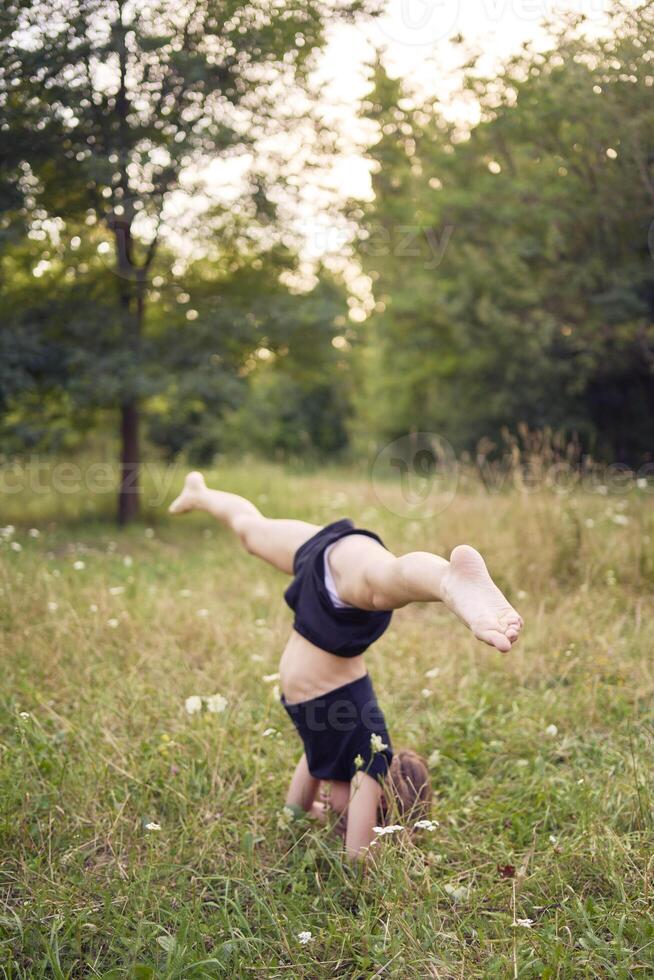 A 10-year-old gymnast practices in the garden photo