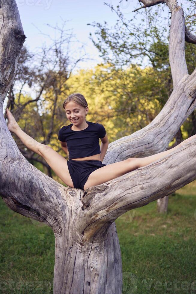 A 10-year-old gymnast practices in the garden photo