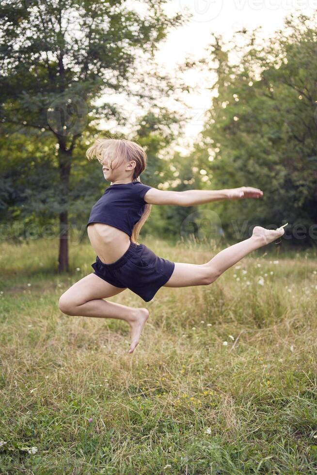 A 10-year-old gymnast practices in the garden photo