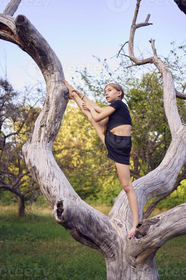 A 10-year-old gymnast practices in the garden photo