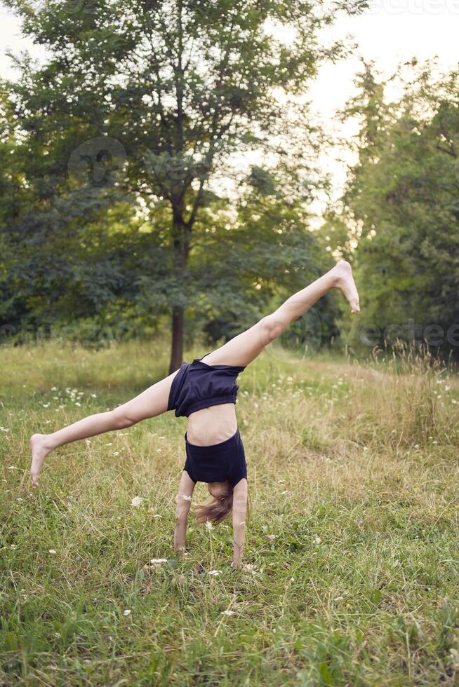 A 10-year-old gymnast practices in the garden photo