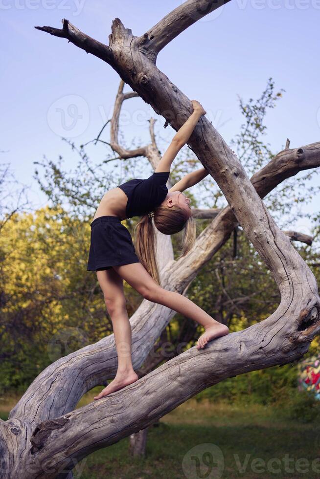 A 10-year-old gymnast practices in the garden photo