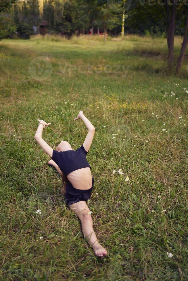 A 10-year-old gymnast practices in the garden photo