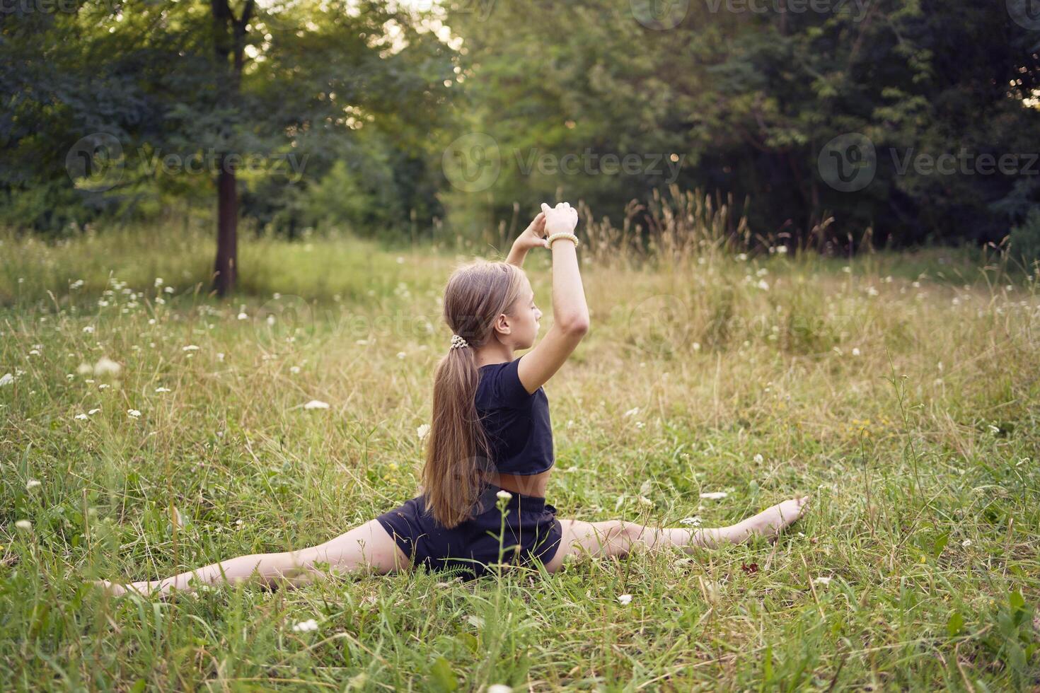A 10-year-old gymnast practices in the garden photo