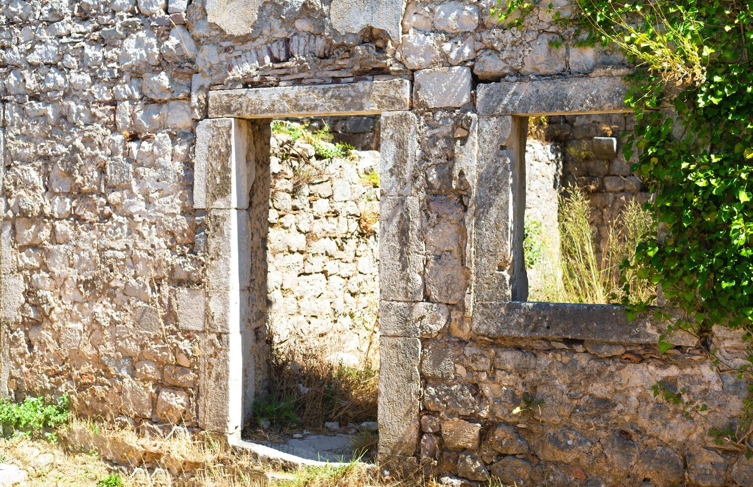 View of the ruins of the ancient old fortress overgrown with plants. Kotor, Montenegro. Selective focus. photo