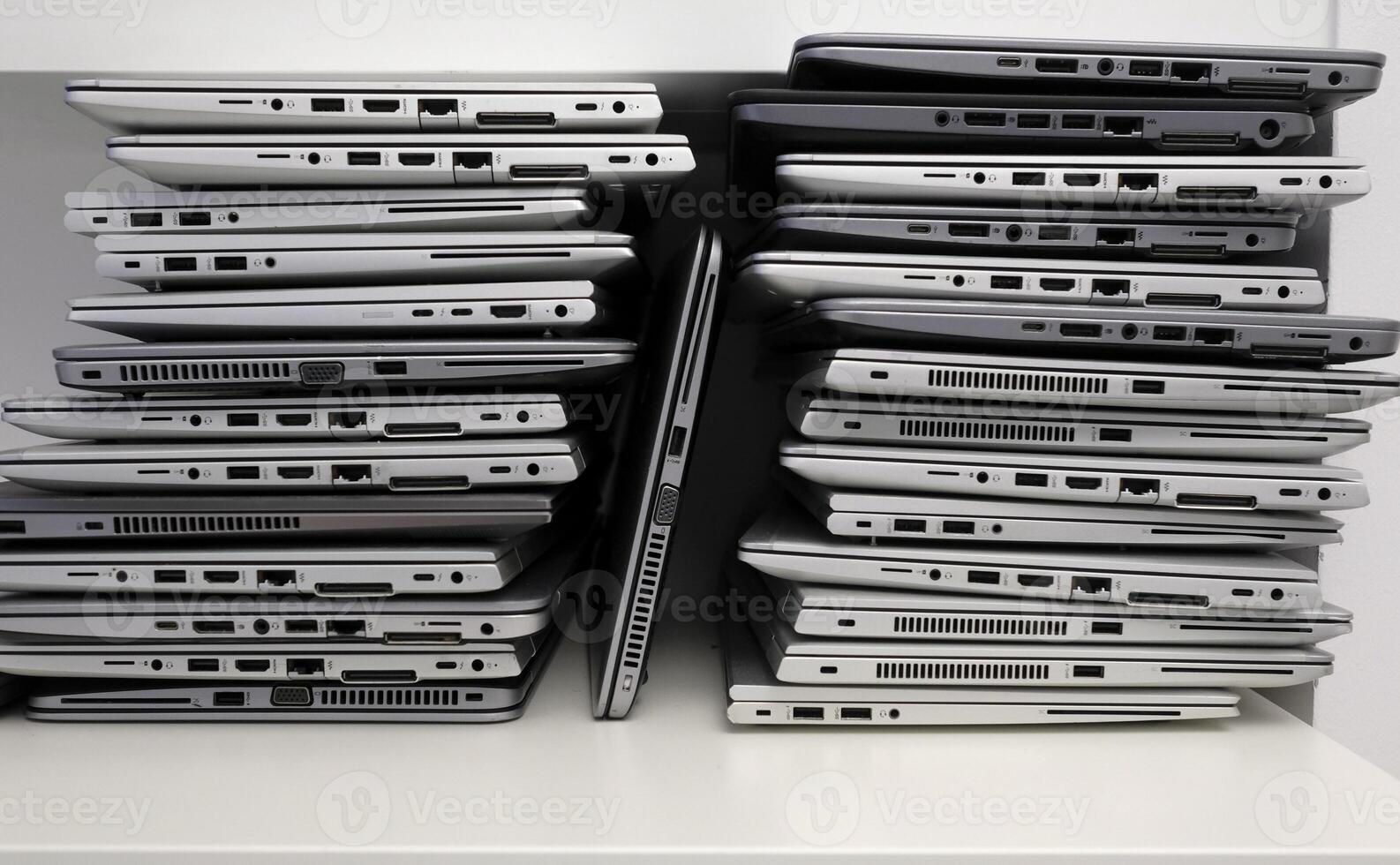 Rack with a stack of laptops in the storage room of a company photo